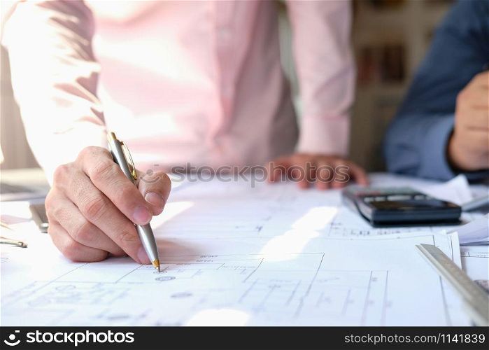 architect engineer team working on house blueprint of real estate project at workplace. building construction teamwork concept