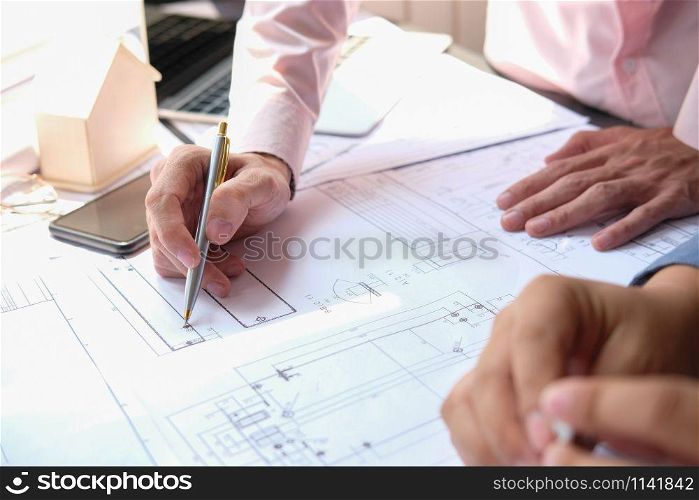architect engineer team working on house blueprint of real estate project at workplace. building construction teamwork concept