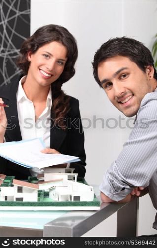 Architect getting customer to sign paperwork