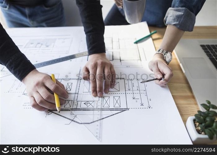 architect hands working blueprint wooden desk office