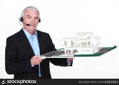 Architect holding replica of housing project