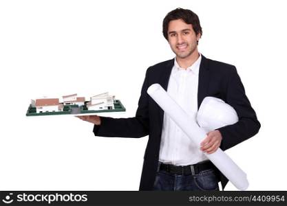 Architect holding scale model of housing