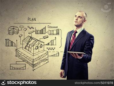Architect holding tablet pc. Image of businessman holding ipad in hands
