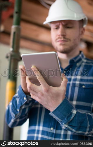 Architect Inside House Being Renovated Using Digital Tablet