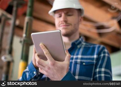 Architect Inside House Being Renovated Using Digital Tablet