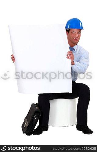 Architect kneeling by poster