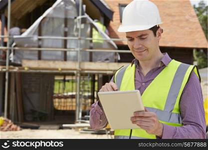 Architect On Building Site Using Digital Tablet