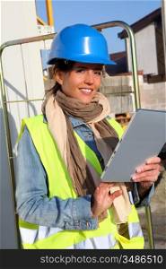 Architect on building site using electronic tablet
