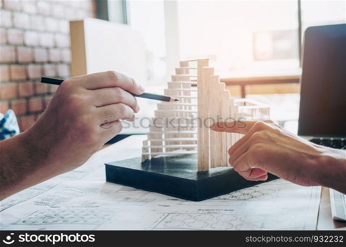 Architect or engineer meeting in office on blueprint And model building. Architects workplace