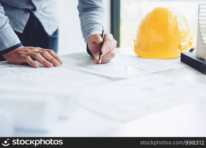 Architect or engineer working in office on blueprint. Architects workplace