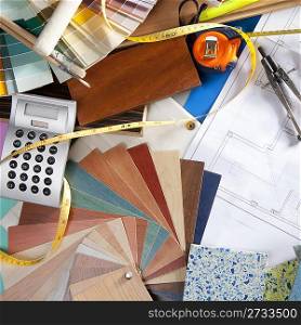 Architect or interior designer workplace desk and design tools with lots of construction material samples