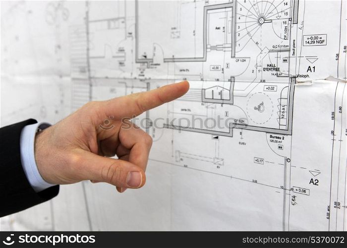 Architect pointing to floor plans