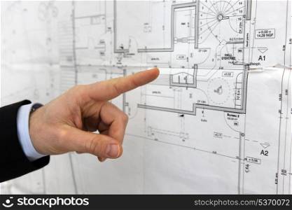 Architect pointing to floor plans