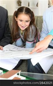 Architect showing designs to young family