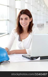 Architect sitting in front of laptop computer