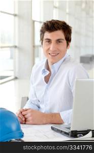 Architect sitting in front of laptop computer