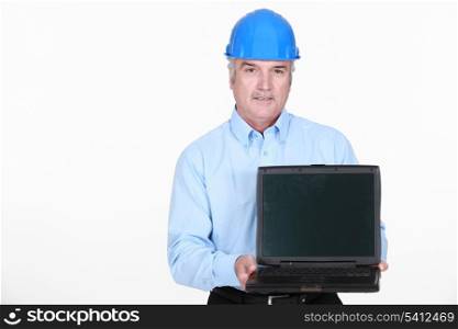 Architect stood holding portable computer