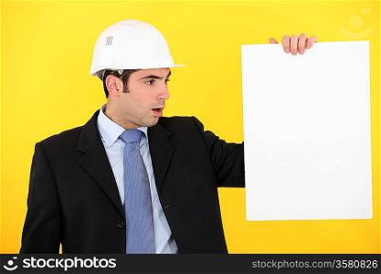 Architect stood with blank poster