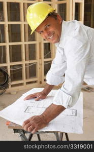 Architect Studying Plans In New Home