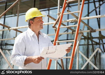 Architect Studying Plans Outside New Home