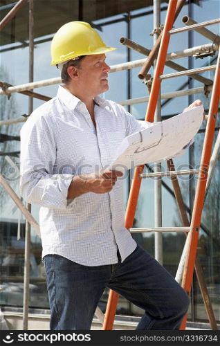 Architect Studying Plans Outside New Home