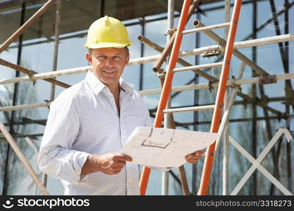 Architect Studying Plans Outside New Home