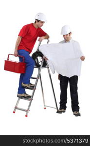 architect unfolding blueprints and electrician on ladder