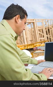 Architect using laptop on construction site