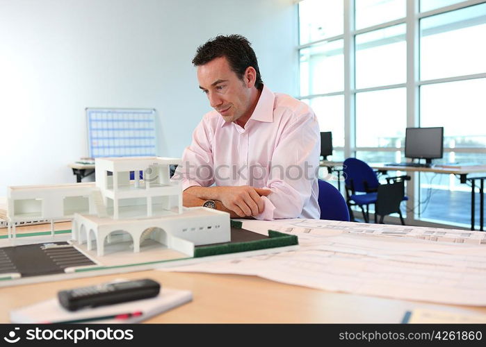 Architect with a model of a building