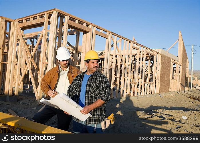 Architect with construction worker in construction site