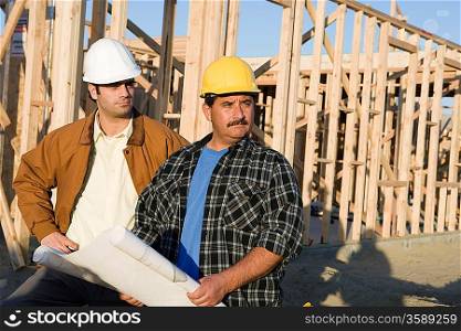 Architect with construction worker in construction site