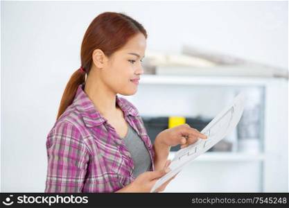 architect woman checking plan in house construction