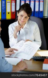 architect woman with a plans and customer