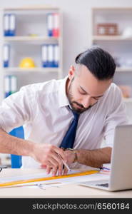 Architect working in his studio on new project