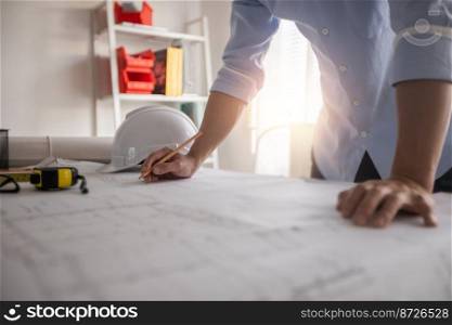 Architect working in office with blueprints,engineer thinking and planning inspection in workplace for architectural plan,sketching a construction project,Business construction concept.