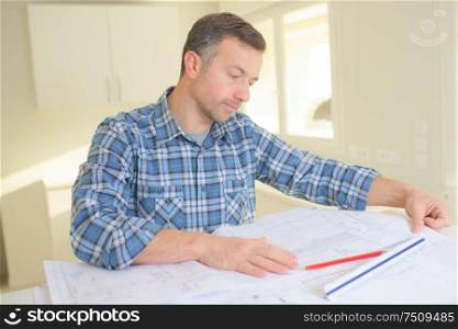 architect working with blueprints in the office
