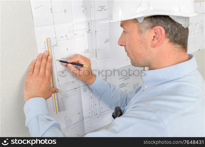 Architect writing on his blue prints