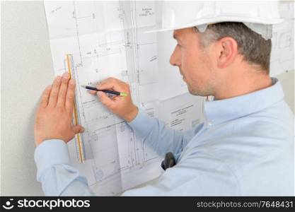 Architect writing on his blue prints