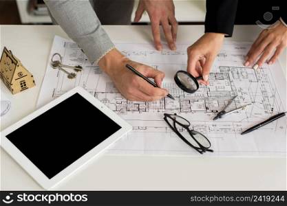 architects analysing plan with magnifier
