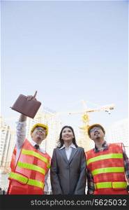 Architects and businesswoman at a construction site, Beijing