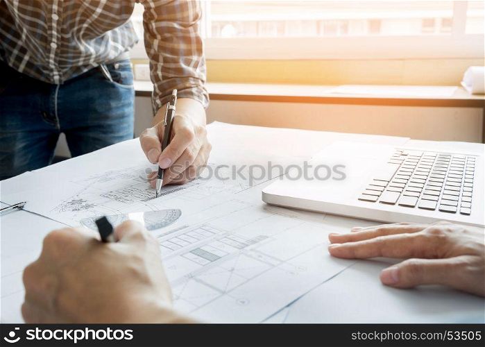 Architects engineer discussing at the table with blueprint - Closeup on hands and project print, Team group on construciton site check documents and business workflow.