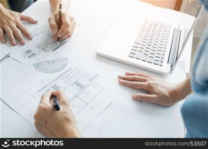 Architects engineer discussing at the table with blueprint - Closeup on hands and project print, Team group on construciton site check documents and business workflow.