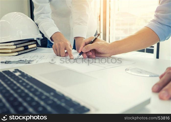 Architects engineer discussing at the table with blueprint - Closeup on hands and project print, Team group on construciton site check documents and business workflow