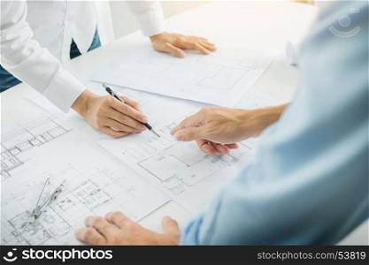 Architects engineer discussing at the table with blueprint - Closeup on hands and project print, Team group on construciton site check documents and business workflow