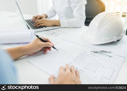 Architects engineer discussing at the table with blueprint - Closeup on hands and project print, Team group on construciton site check documents and business workflow