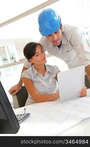 Architects working in office with electronic tablet