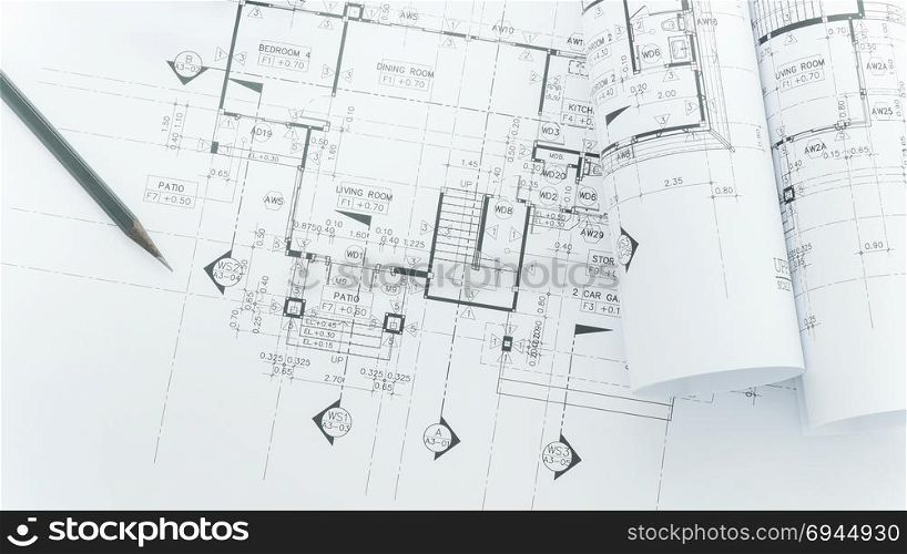 architects workplace - architectural blueprints with measuring tape, safety helmet and tools on table. top view