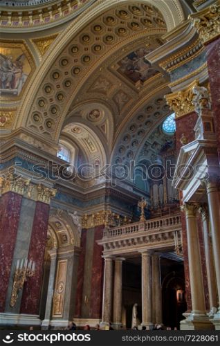 Architectural and painting decoration of interior beautiful Catholic Cathedral with marble statues and sculptures in Budapest, Hungary.. Architectural style of beautiful interior of Catholic Cathedral with decoration in Budapest.