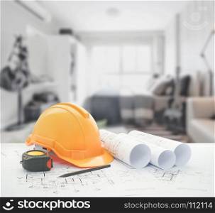 architectural blueprint with safety helmet and tools over bedroom with sofa as background
