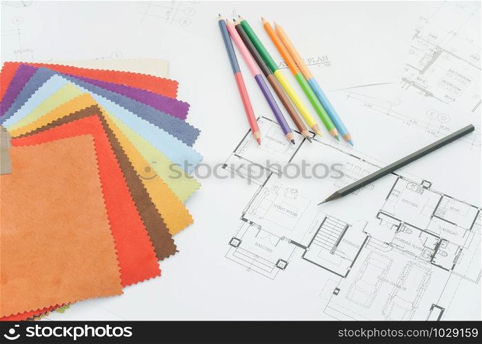 Architectural drawing with sample of material on working desk